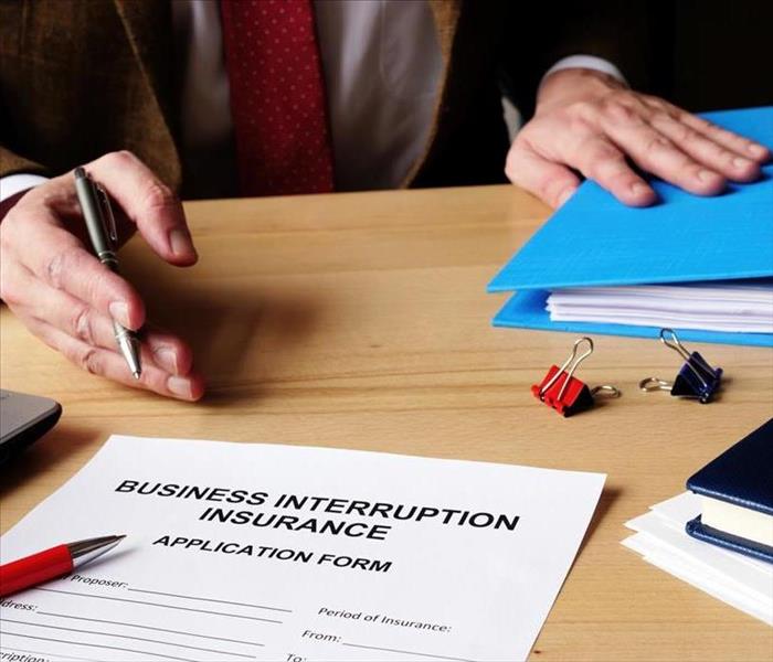 The agent provides business interruption insurance application documents.