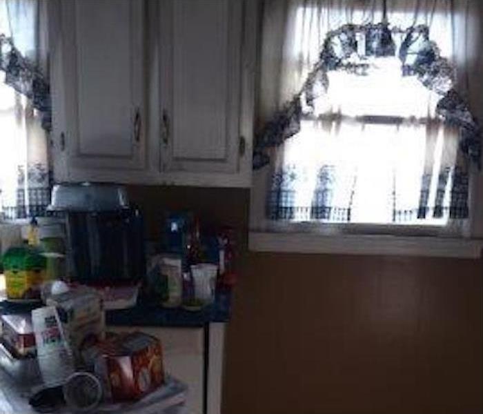Window in a kitchen, kitchen cabinets, fire damage in kitchen area